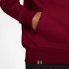 Detail eines Kapuzenpullovers mit Tasche und farbigem Patch am Saum.
