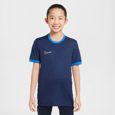 Junge in dunkelblauem Nike-Shirt mit blauem Kragen und Ärmelbund. Junge in dunkelblauem Nike-Shirt mit blauem Kragen und Ärmelbund.