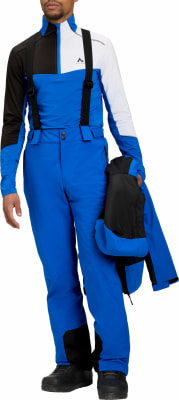 Mann in blauer Skihose und Jacke mit schwarzen und weißen Akzenten. Mann in blauer Skihose und Jacke mit schwarzen und weißen Akzenten.