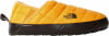 Zateplená žltá nazúvacia topánka s čiernou podrážkou a logom The North Face.