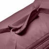 Detail eines oberen Griffs einer Stofftasche in Rosa mit feinem Muster.