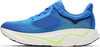 Blauer Laufschuh mit weißer Sohle und grünen Akzenten.