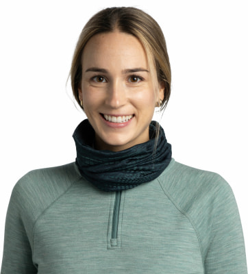 Eine lächelnde Frau trägt einen dunkelblauen Schlauchschal und einen hellgrünen Pullover.