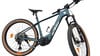 Grünes E-Mountainbike mit braunen Reifen und weißem KTM-Logo.