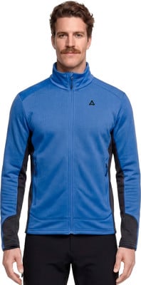 Ein Mann in einer blauen Fleecejacke mit schwarzen Einsätzen und einem Logo auf der Brust. Ein Mann in einer blauen Fleecejacke mit schwarzen Einsätzen und einem Logo auf der Brust.