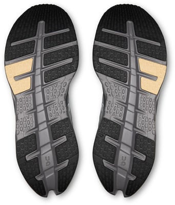 Schuhsohle mit Wabenmuster und beigen Elementen.