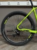 Grünes Mountainbike mit Scheibenbremse und großer Kassette hinten.