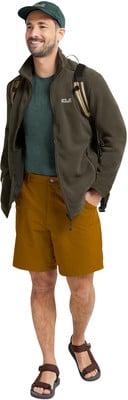 Ein Mann in einer grünen Jacke, braunen Shorts und Sandalen steht. Ein Mann in einer grünen Jacke, braunen Shorts und Sandalen steht.