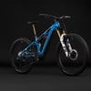 Ein blaues E-Mountainbike mit Federung und goldenen Akzenten.