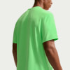 Mann in einem leuchtend grünen kurzärmeligen T-Shirt von hinten gesehen.