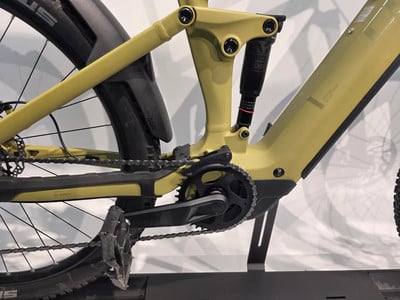 Detail der Rückseite eines gelben E-Bikes mit Dämpfer und Pedalen. Detail der Rückseite eines gelben E-Bikes mit Dämpfer und Pedalen.