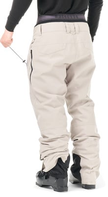 Rückansicht einer hellbeigen Skihose mit schwarzen Stiefeln. Rückansicht einer hellbeigen Skihose mit schwarzen Stiefeln.