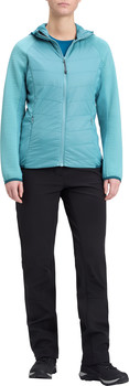 Eine Frau in einer blaugrünen Daunenjacke mit Kapuze und schwarzen Hosen.