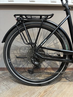 Hinterrad eines schwarzen Fahrrads mit Schutzblech und Gepäckträger. Hinterrad eines schwarzen Fahrrads mit Schutzblech und Gepäckträger.