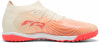 Cremefarbener Fußballschuh mit orange-gestreiftem Design und pinker Sohle.