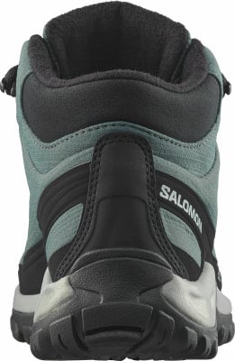 Rückansicht eines dunkelgrünen Salomon Wanderschuhs mit schwarzen Details. Rückansicht eines dunkelgrünen Salomon Wanderschuhs mit schwarzen Details.