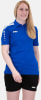 Eine Frau in einem blauen Poloshirt und schwarzen Shorts mit Jako-Logo.