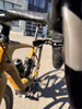 Detailansicht eines Fahrradlenkers mit Griffen und einer Trinkflasche.
