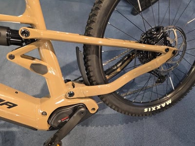 Detail eines E-Bikes mit Dämpfer, Schaltwerk und Maxxis-Felge. Detail eines E-Bikes mit Dämpfer, Schaltwerk und Maxxis-Felge.