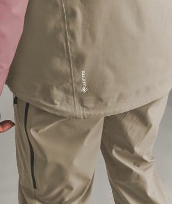 Detail einer Jacke mit GORE-TEX-Logo und beiger Hose. Detail einer Jacke mit GORE-TEX-Logo und beiger Hose.