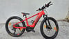 Ein rotes KTM E-Bike mit Federgabel und schwarzen Reifen.