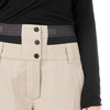 Detail einer Damen-Skihose in Beige mit schwarzem Bund und Knöpfen.