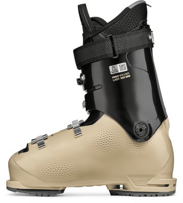 Ein beige und schwarzer Skischuh mit Schnallen und Riemen.