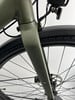 Detail der vorderen Gabel eines grünen Fahrrads mit Schutzblech und Licht.