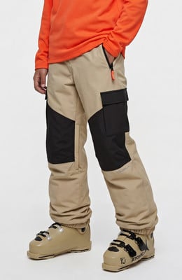 Skihose in Beige mit schwarzen Einsätzen und Skischuhen.