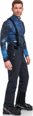 Ein Mann in Skibekleidung mit blauem Oberteil und schwarzer Hose. Ein Mann in Skibekleidung mit blauem Oberteil und schwarzer Hose.