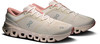 Beige Laufschuhe mit rosa Akzenten und weißer Sohle.