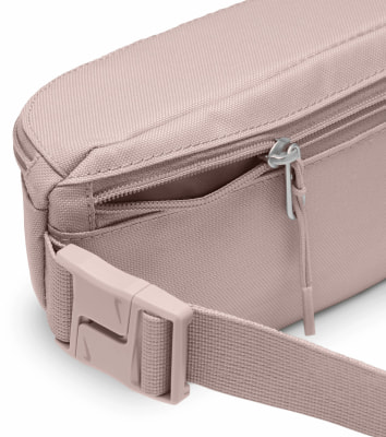 Eine rosa Nike Bauchtasche mit verstellbarem Gurt und Schnallenverschluss. Eine rosa Nike Bauchtasche mit verstellbarem Gurt und Schnallenverschluss.