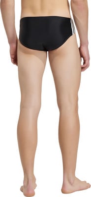 Rückansicht eines Mannes in schwarzer Badehose mit weißen Streifen. Rückansicht eines Mannes in schwarzer Badehose mit weißen Streifen.