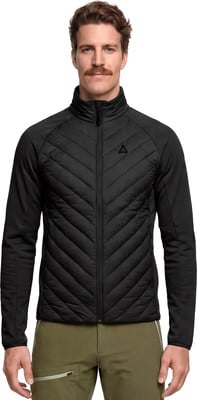 Ein Mann in einer schwarzen gesteppten Jacke und grüner Hose mit Schnurrbart. Ein Mann in einer schwarzen gesteppten Jacke und grüner Hose mit Schnurrbart.