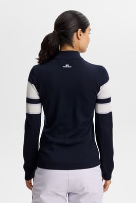Dunkelblauer Damenpullover mit weißen Ärmelstreifen und Logo. Dunkelblauer Damenpullover mit weißen Ärmelstreifen und Logo.