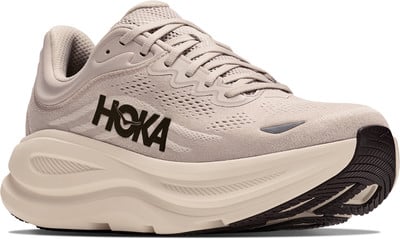 Beige Hoka Laufschuhe mit markanter Zwischensohle und Markenlogo. Beige Hoka Laufschuhe mit markanter Zwischensohle und Markenlogo.