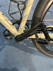 Detail eines Fahrrads mit Kette und Pedalen auf einem blauen Teppich.