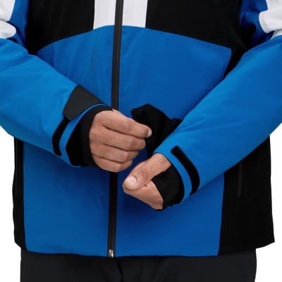 Ein Mann schließt seinen Handschuh an einer Jacke, blaue Jacke mit schwarzen Details. Ein Mann schließt seinen Handschuh an einer Jacke, blaue Jacke mit schwarzen Details.