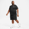 Ein Mann in einem schwarzen Nike-T-Shirt und Shorts mit weißen Turnschuhen.