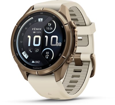 Eine Garmin Fenix Smartwatch mit beigem Armband und goldenem Rahmen. Eine Garmin Fenix Smartwatch mit beigem Armband und goldenem Rahmen.
