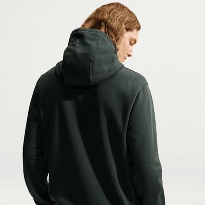 Rückansicht eines Mannes mit langen Haaren in einem dunkelgrünen Kapuzenpullover. Rückansicht eines Mannes mit langen Haaren in einem dunkelgrünen Kapuzenpullover.
