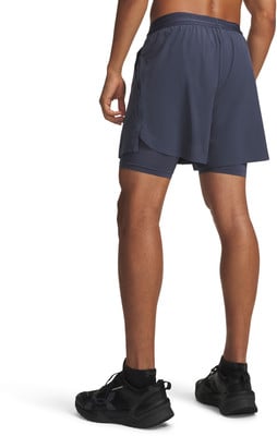 Mann in dunkelblauen Shorts mit integrierten Leggings und schwarzen Turnschuhen. Mann in dunkelblauen Shorts mit integrierten Leggings und schwarzen Turnschuhen.