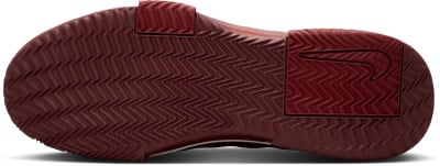 Dunkelrotes Schuhsohle mit ausgeprägtem Fischgrätenmuster und Nike-Logo. Dunkelrotes Schuhsohle mit ausgeprägtem Fischgrätenmuster und Nike-Logo.