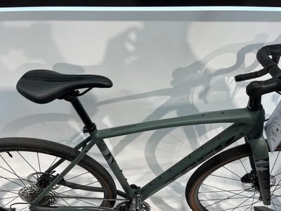 Ein grünes Gravelbike mit schwarzem Sattel und Lenker. Ein grünes Gravelbike mit schwarzem Sattel und Lenker.