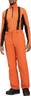 Ein Mann in orangefarbener Skihose mit Hosenträgern und schwarzer Jacke. Ein Mann in orangefarbener Skihose mit Hosenträgern und schwarzer Jacke.