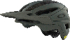 Grüner Oakley Fahrradhelm mit Visier und MIPS-Logo.