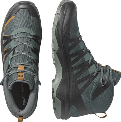 Herren-Wanderschuhe von Salomon in Dunkelgrün mit orangefarbenen Akzenten. Herren-Wanderschuhe von Salomon in Dunkelgrün mit orangefarbenen Akzenten.