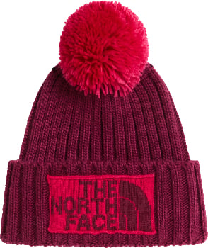 Eine rote Strickmütze mit Bommel und The North Face Logo.