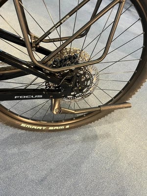Hinterrad eines schwarzen Fahrrads mit Gepäckträger und Scheibenbremse. Hinterrad eines schwarzen Fahrrads mit Gepäckträger und Scheibenbremse.