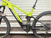 Grünes E-Bike mit schwarzen Details und Federung.
